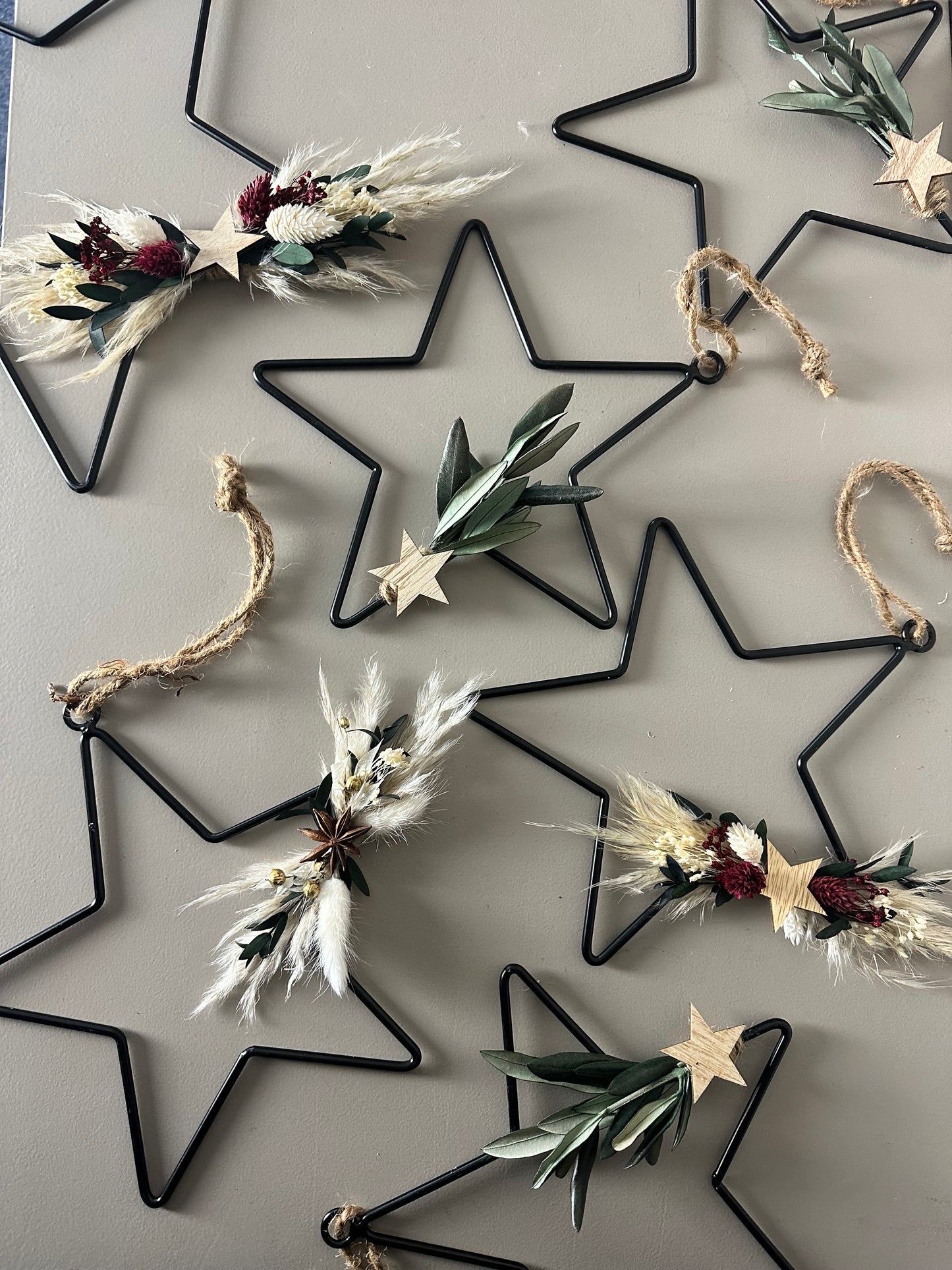 black metal star with dried flowers