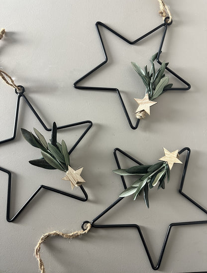 black metal star with dried flowers