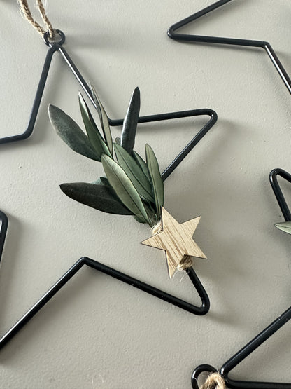 black metal star with dried flowers