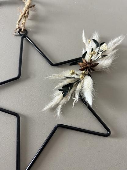 black metal star with dried flowers