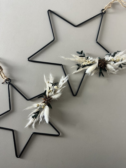 black metal star with dried flowers