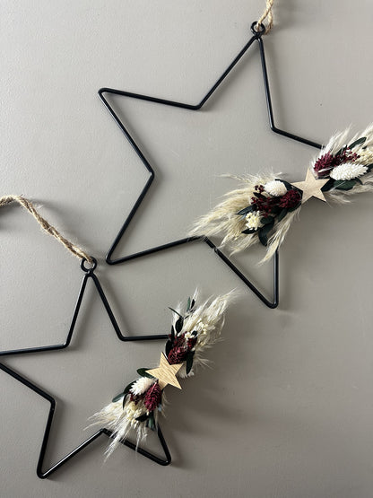 black metal star with dried flowers