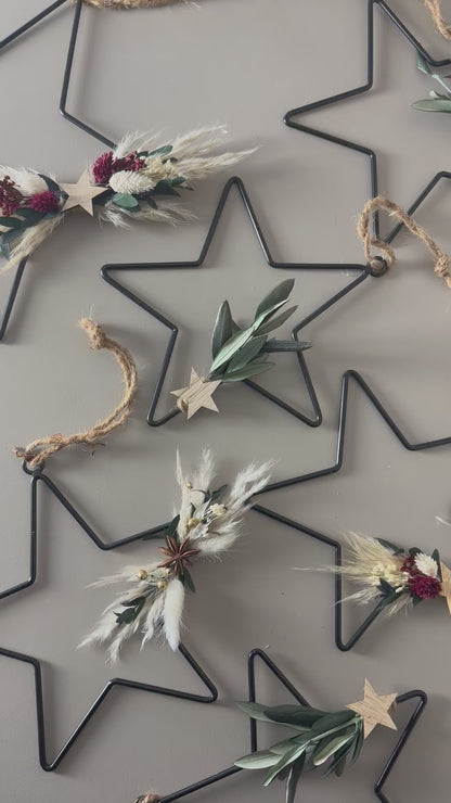 black metal star with dried flowers