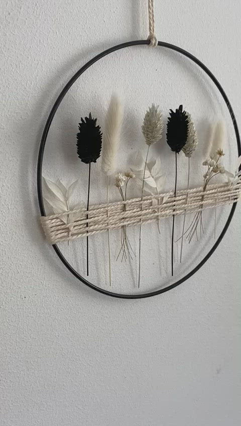 Metal ring with black and white dried flowers