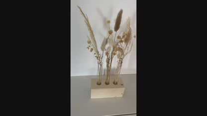 Wooden block with test tubes and dried flowers